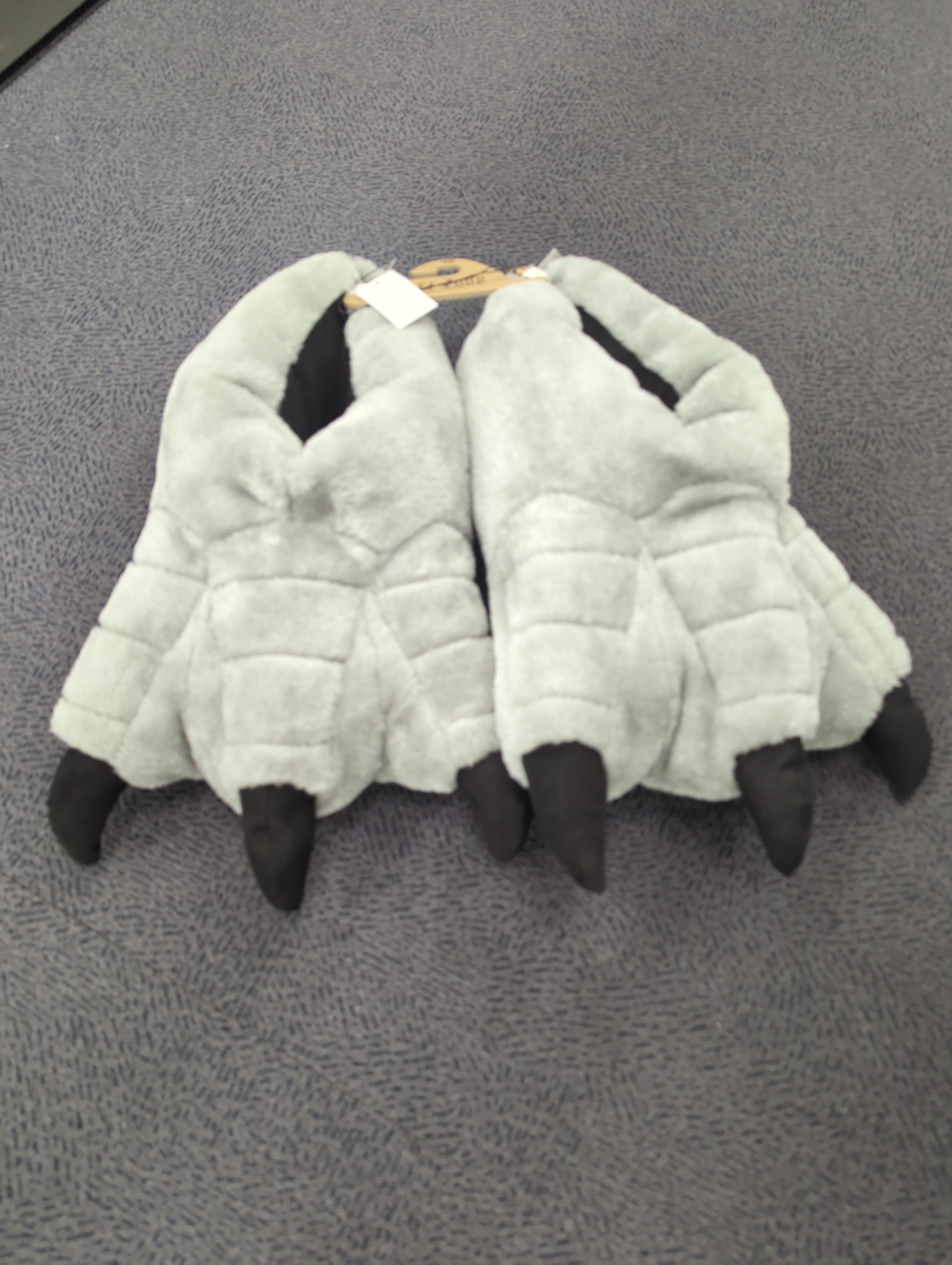 picture of slippers with big claws like dinosaur feet, grey